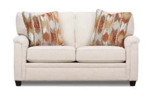 Cream fabric loveseat with patterned pillows, furniture retouching