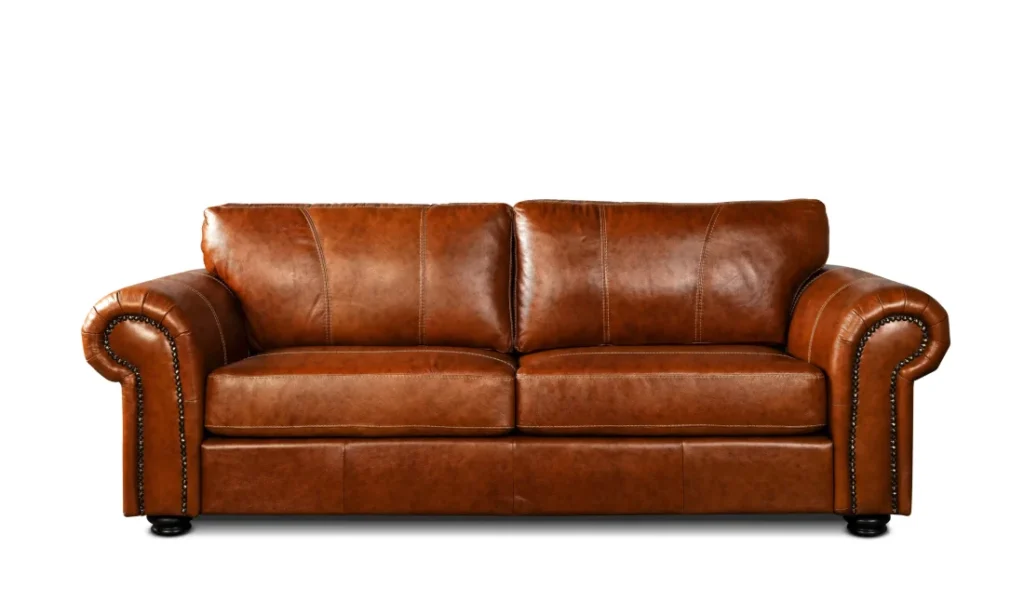 Tan leather rolled-arm sofa with nailhead trim, furniture retouching